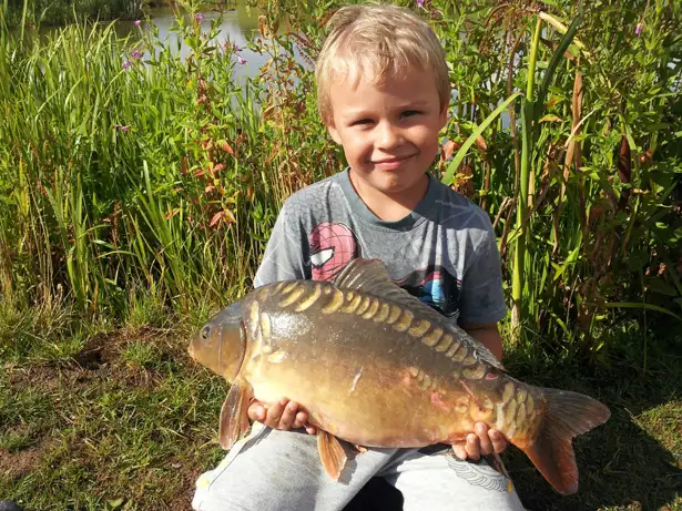 Sent in by Kelly Higgs - Six Year Old Samuel With A Carp Caught On His First Night Fishing With Daddy